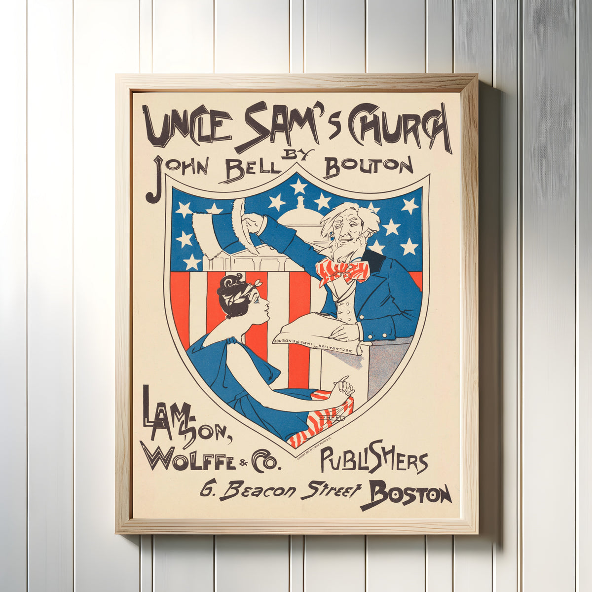 Framed art print of Uncle Sam's Church by Ethel Reed, in a light wood frame on a white panelled wall