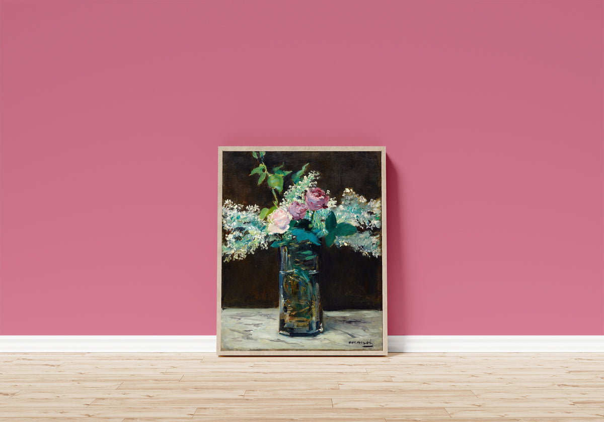 Framed art print of Vase of White Lilacs and Roses by Édouard Manet, in a light wood frame leaning on a pink wall above a wooden floor