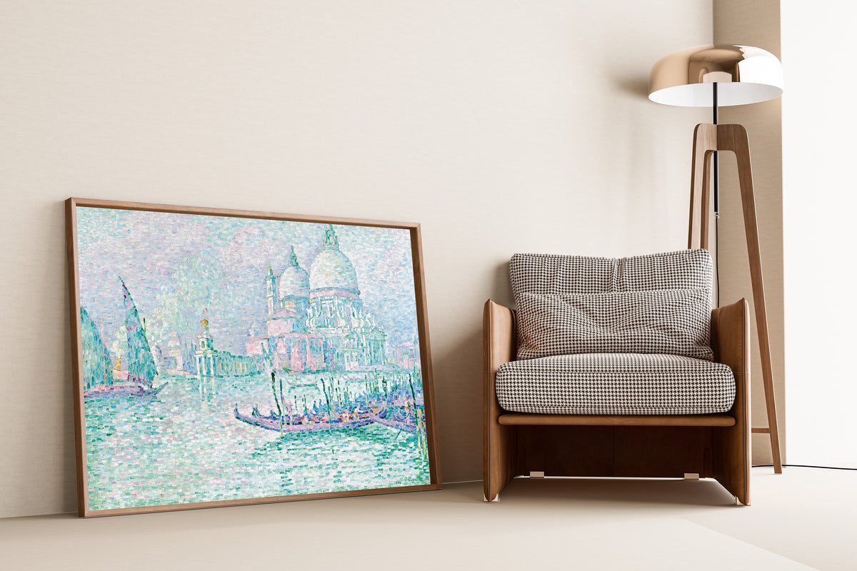 Framed art print of Venice, La Salute, Green by Paul Signac, leaning against a wall beside an armchair and a floor lamp