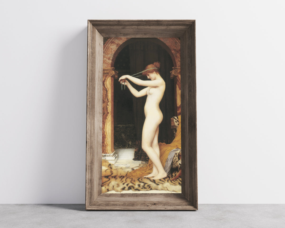 Framed art print of Venus Binding Her Hair by John William Godward, in a wide wooden frame leaning against a concrete wall