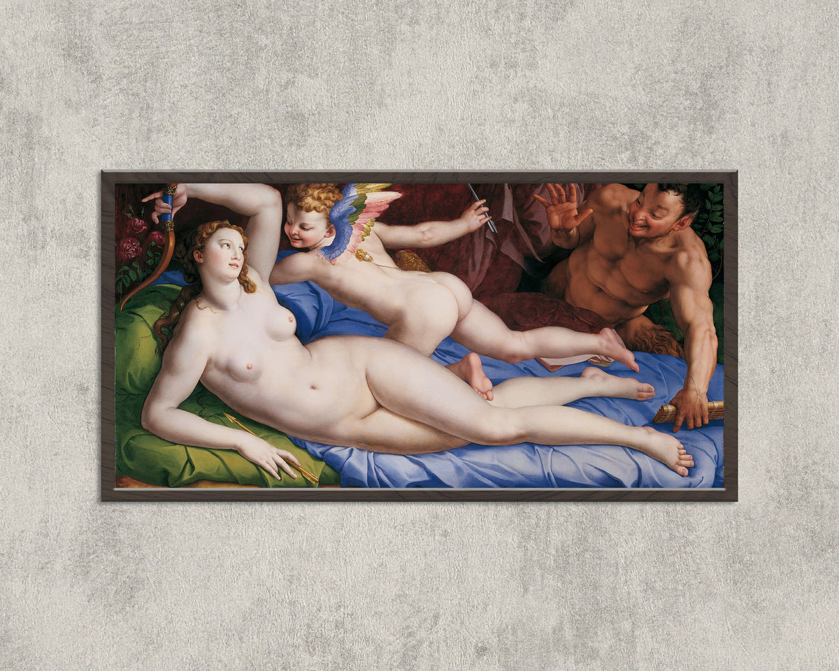 Framed art print of Venus, Cupid and Satyr by Bronzino, in a wide black frame on a concrete wall