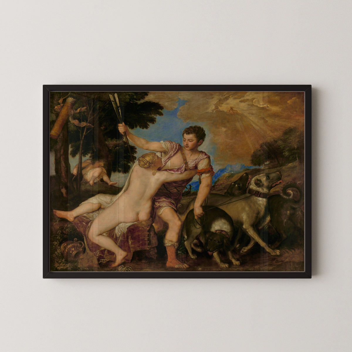 Framed art print of Venus and Adonis by Titian, in a black frame on a pale wall