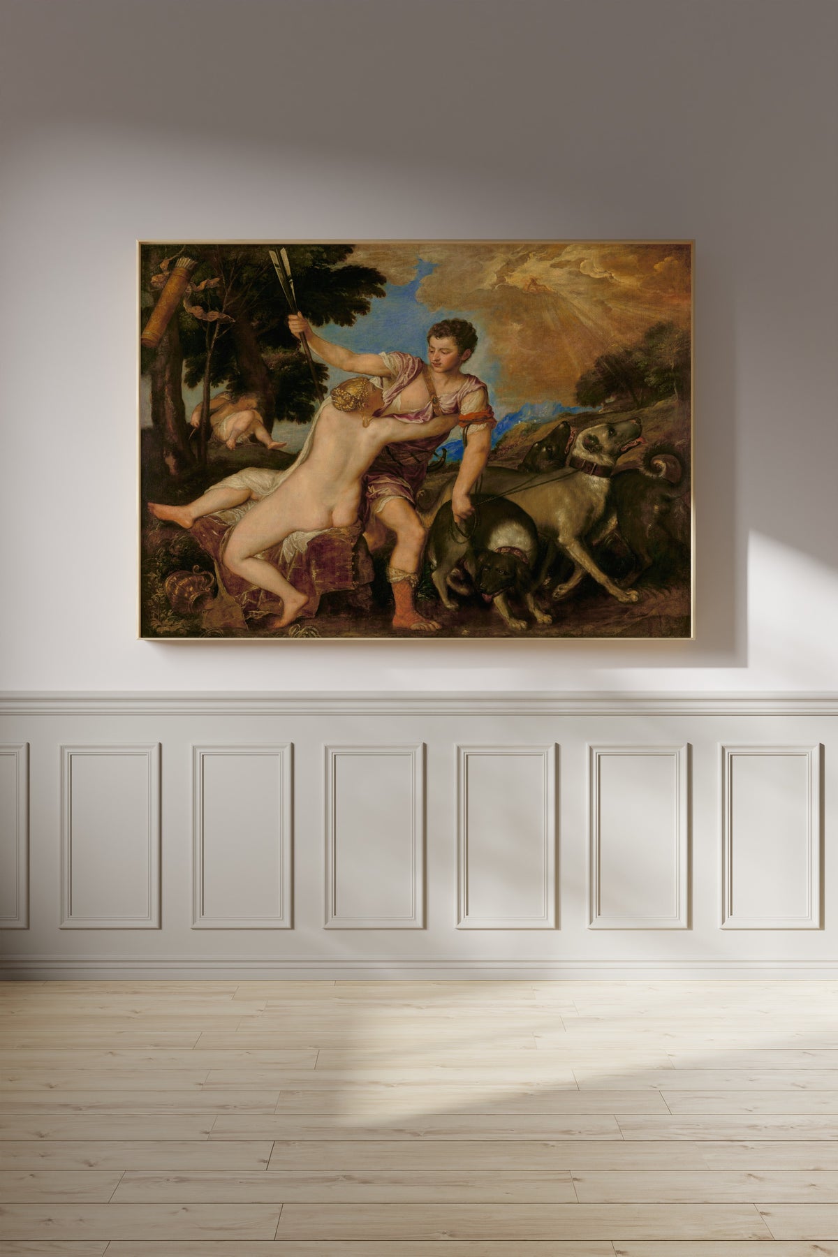 Framed art print of Venus and Adonis by Titian, on a panelled wall in afternoon light