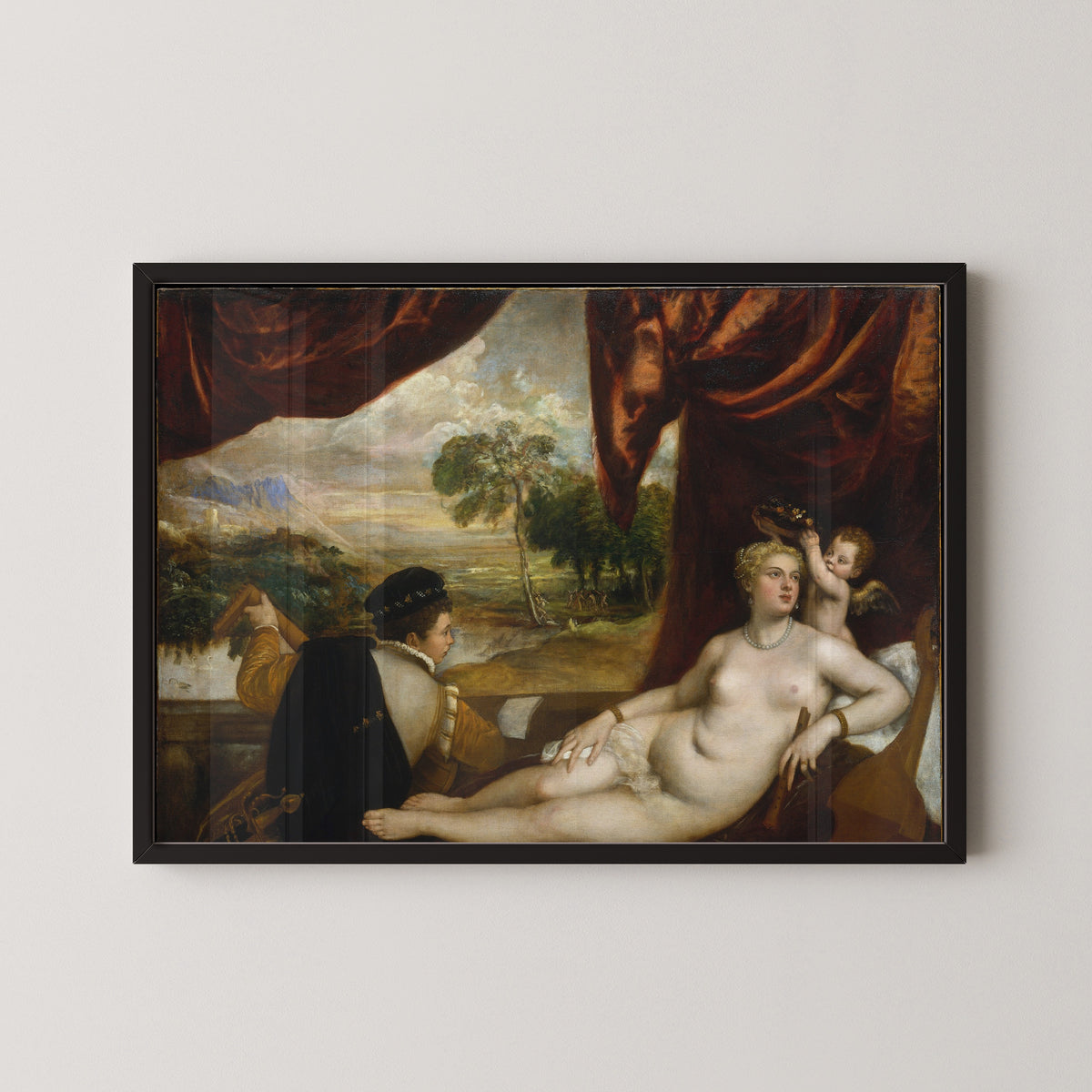 Framed art print of Venus and the Lute Player by Titian, in a black frame on a pale wall