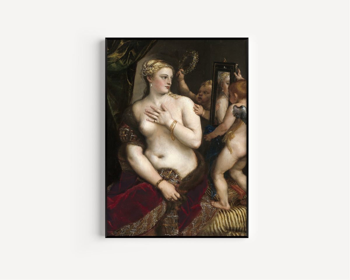 Framed art print of Venus with a Mirror by Titian, in a slim black frame on a plain white wall