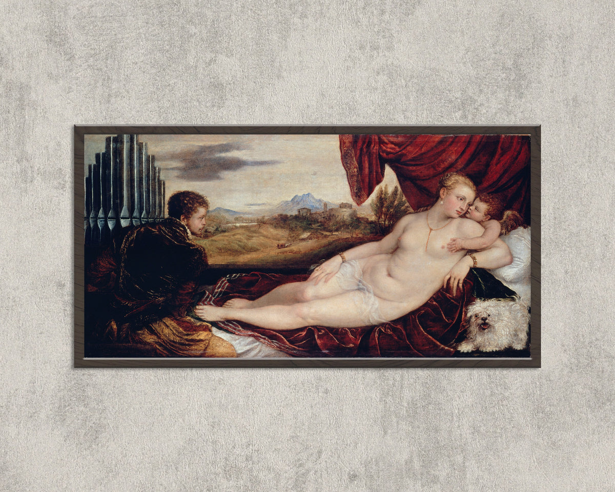 Framed art print of Venus with the Organ Player by Titian, in a wide black frame on a concrete wall