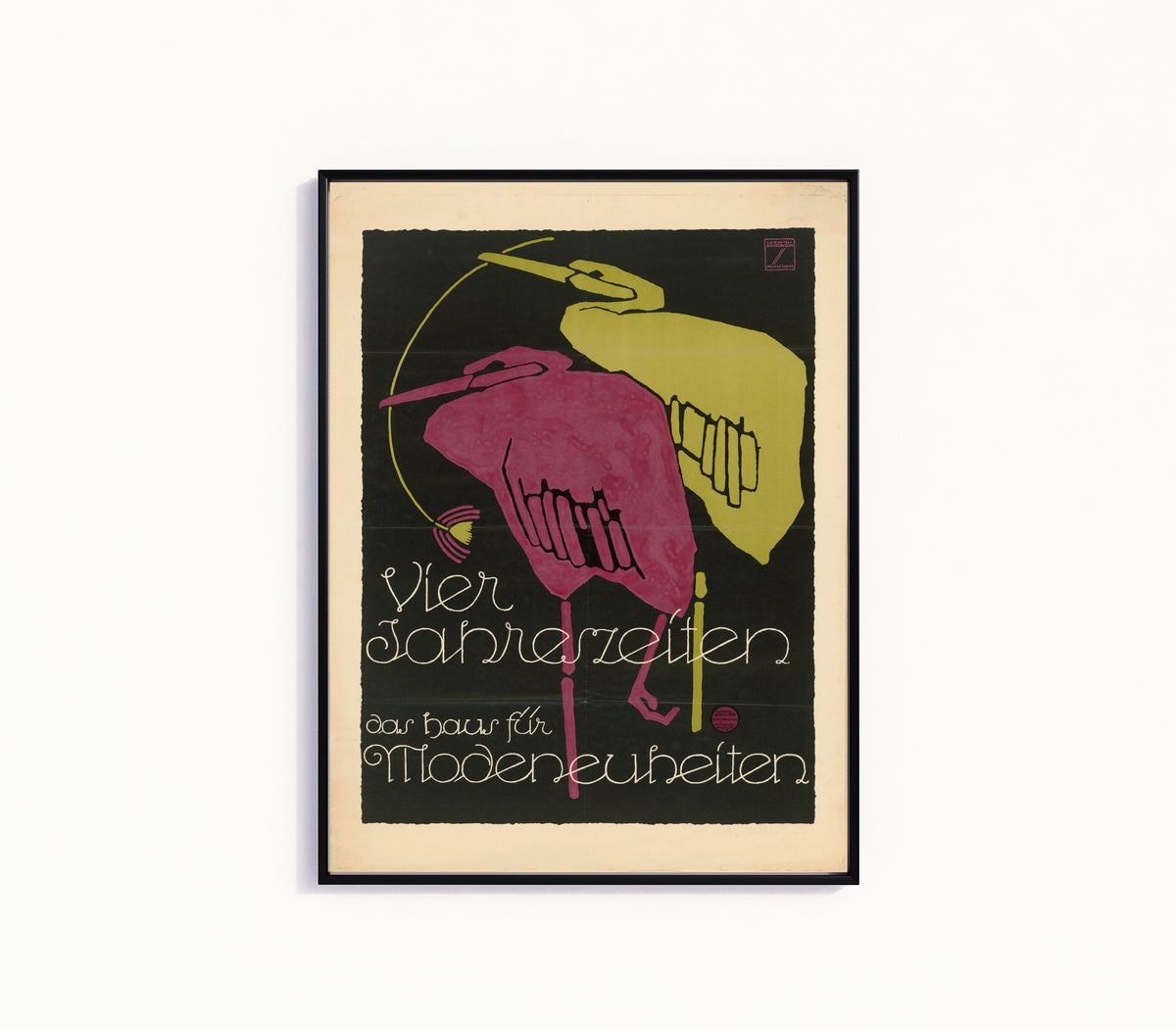 Framed art print of Vier Jahreszeiten: Das Haus für Modeneuheiten by Ludwig Hohlwein, in a slim black frame on a plain white wall