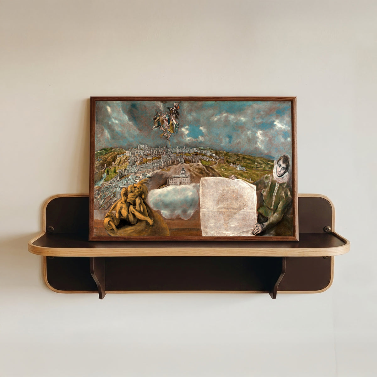 Framed art print of View and Plan of Toledo by El Greco, in a dark wood frame resting on a wall shelf