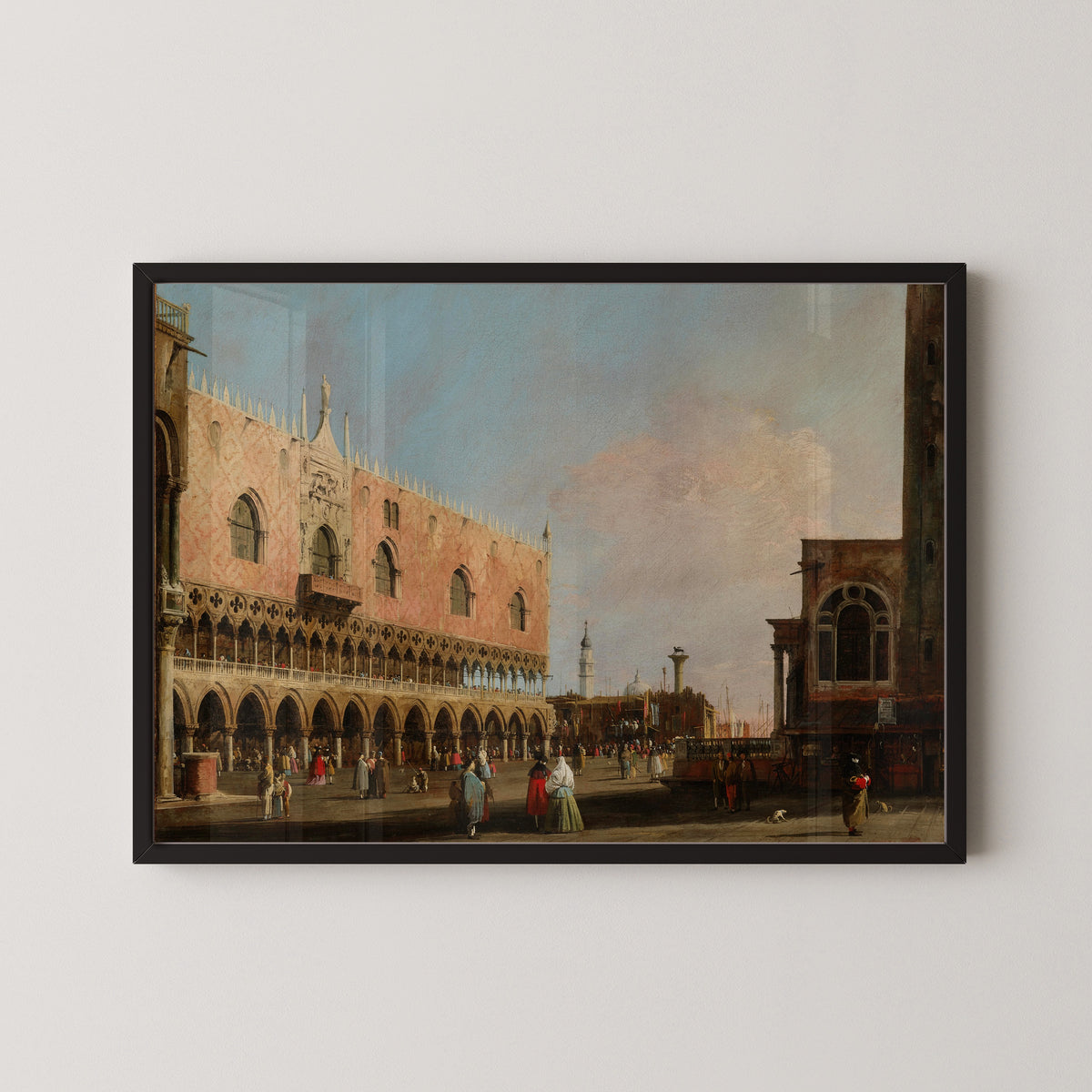 Framed art print of View of the Piazzetta San Marco Looking South by Canaletto, in a black frame on a pale wall