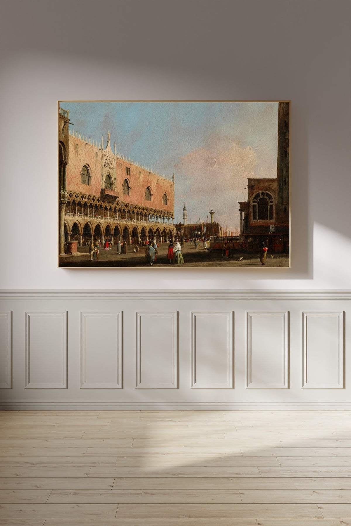 Framed art print of View of the Piazzetta San Marco Looking South by Canaletto, on a panelled wall in afternoon light
