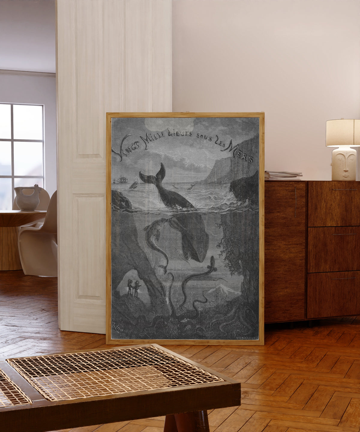 Framed art print of Vingt mille lieues sous les mers: title vignette… by Édouard Riou, in a light wood frame leaning in a warm room with a parquet floor