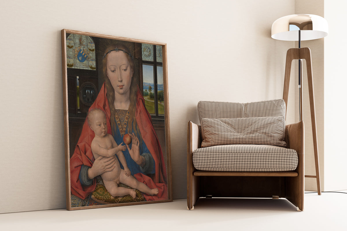 Framed art print of Virgin Mary with the Child Jesus by Hans Memling, leaning against a wall beside an armchair and a floor lamp