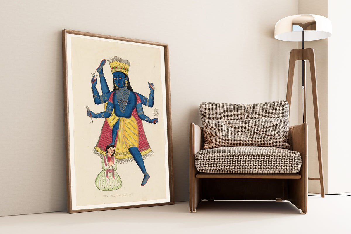 Framed art print of Vishnu as Vamana defeating King Mahabali by Kalighat painter, leaning against a wall beside an armchair and a floor lamp