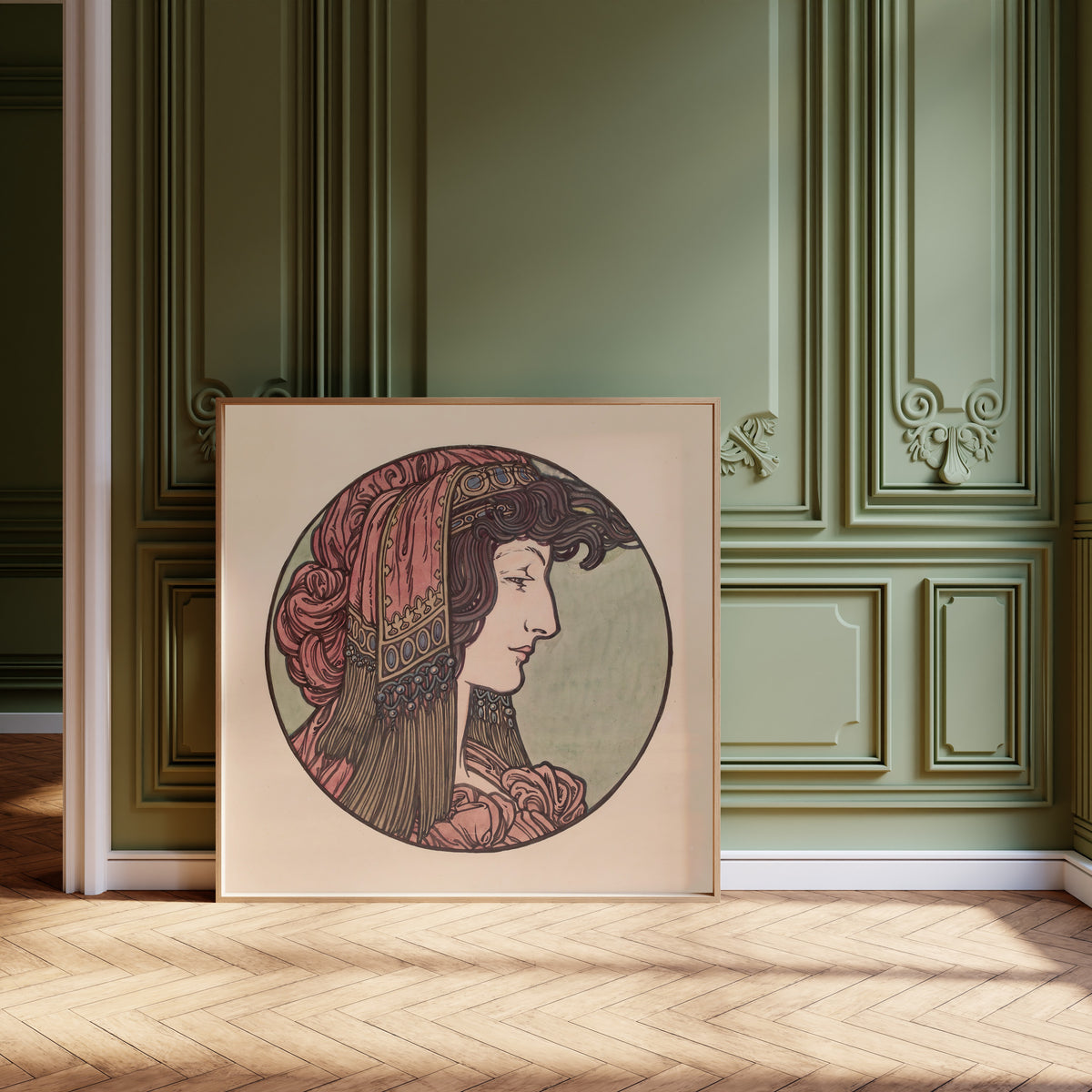 Framed art print of Vitrail pour la façade de la boutique Fouquet (pink… by Alphonse Mucha, leaning against olive-green panelling on a herringbone floor