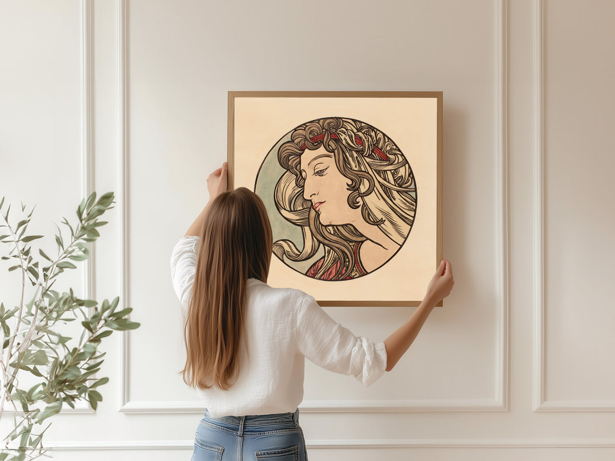 Framed art print of Vitrail pour la façade de la boutique Fouquet (red headband) by Alphonse Mucha, hung on a panelled wall