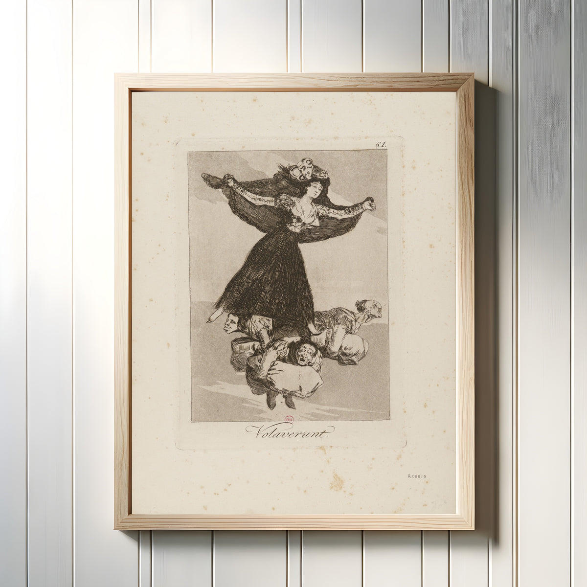 Framed art print of Volaverunt (They Have Flown), Los Caprichos, Plate 61 by Francisco de Goya, in a light wood frame on a white panelled wall