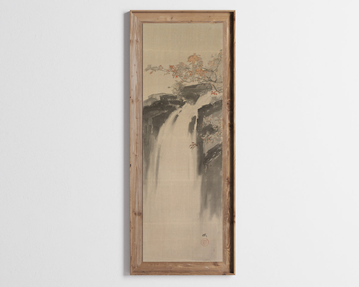 Framed art print of Waterfall by Hiroshi Yoshida, in a tall wooden frame on a pale wall