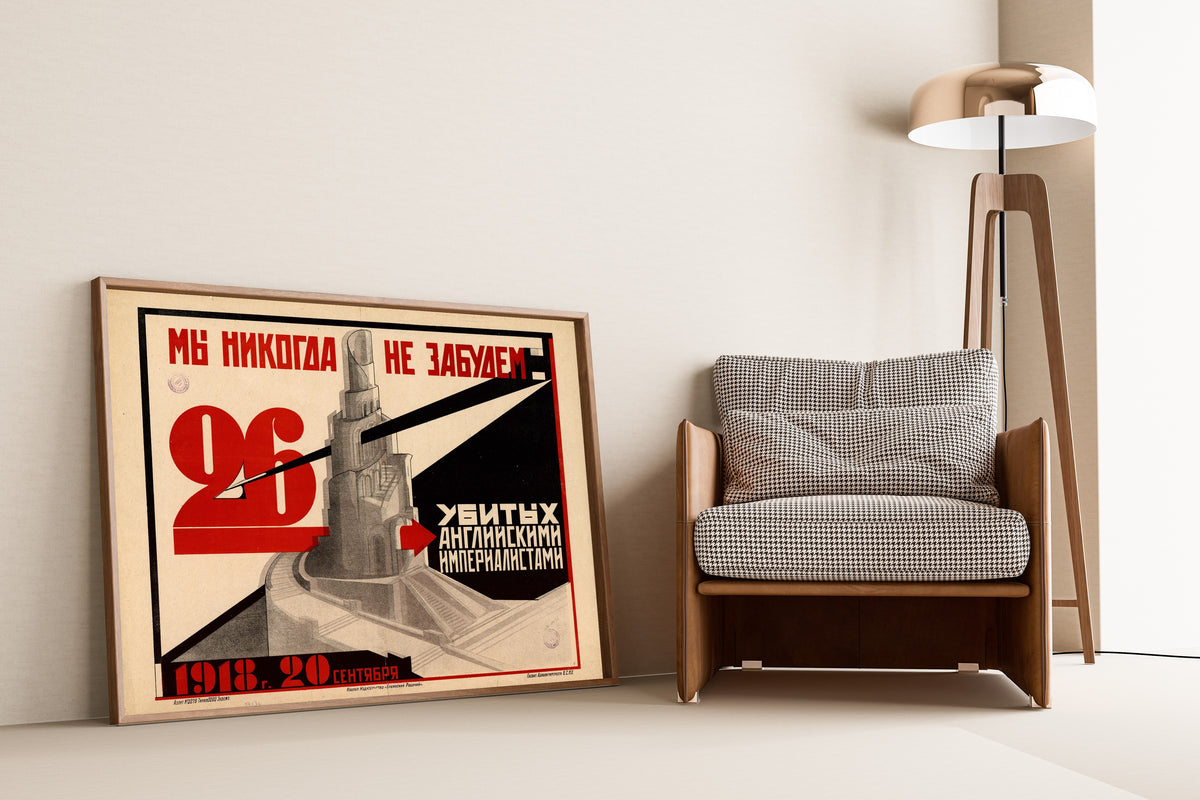 Framed art print of We Will Never Forget the 26 Killed by the English Imperialists. 20 September…, leaning against a wall beside an armchair and a floor lamp