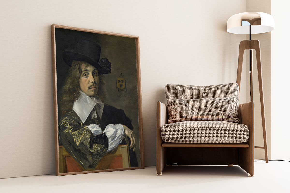 Framed art print of Willem Coymans by Frans Hals, leaning against a wall beside an armchair and a floor lamp