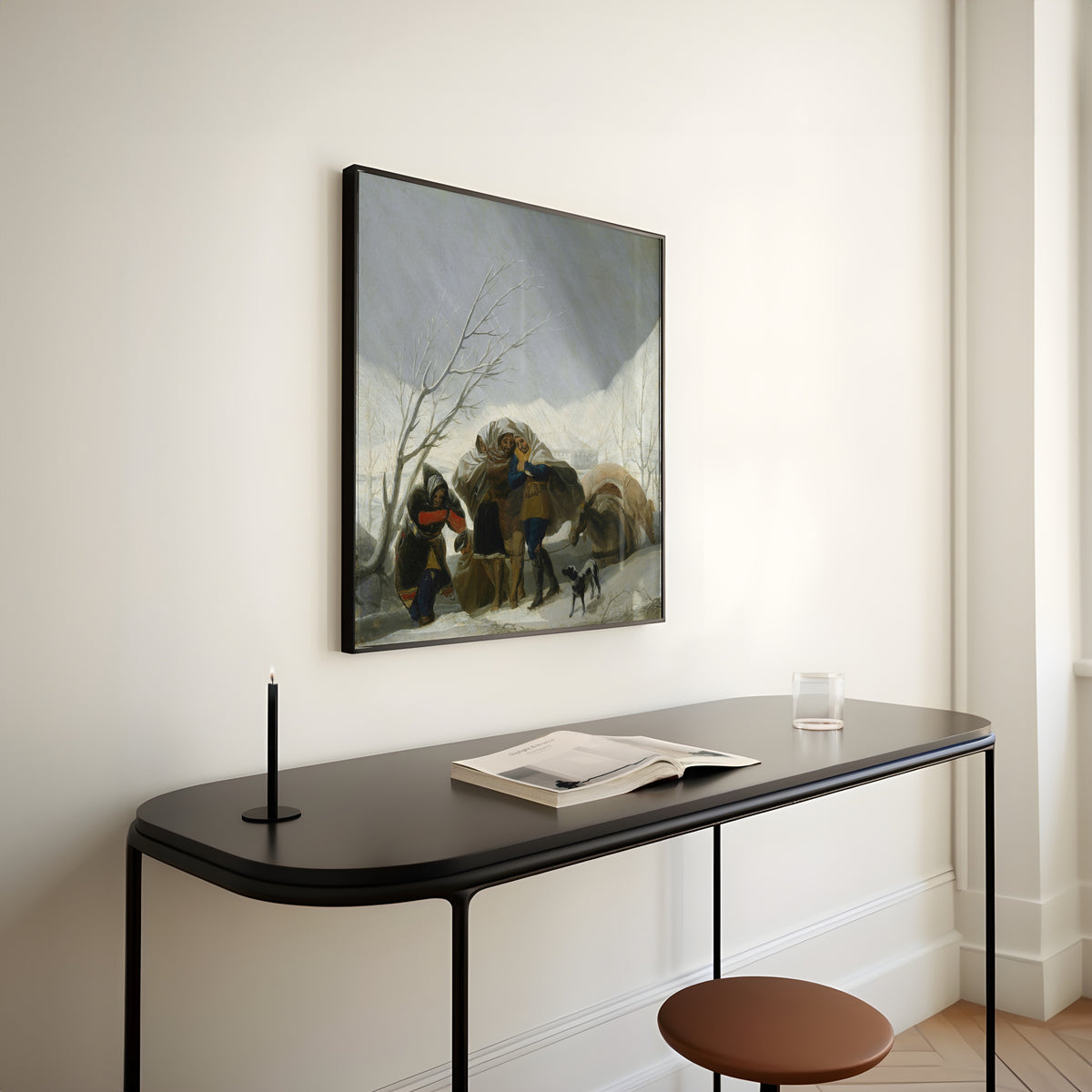 Framed art print of Winter Scene by Francisco de Goya, above a slim black console table