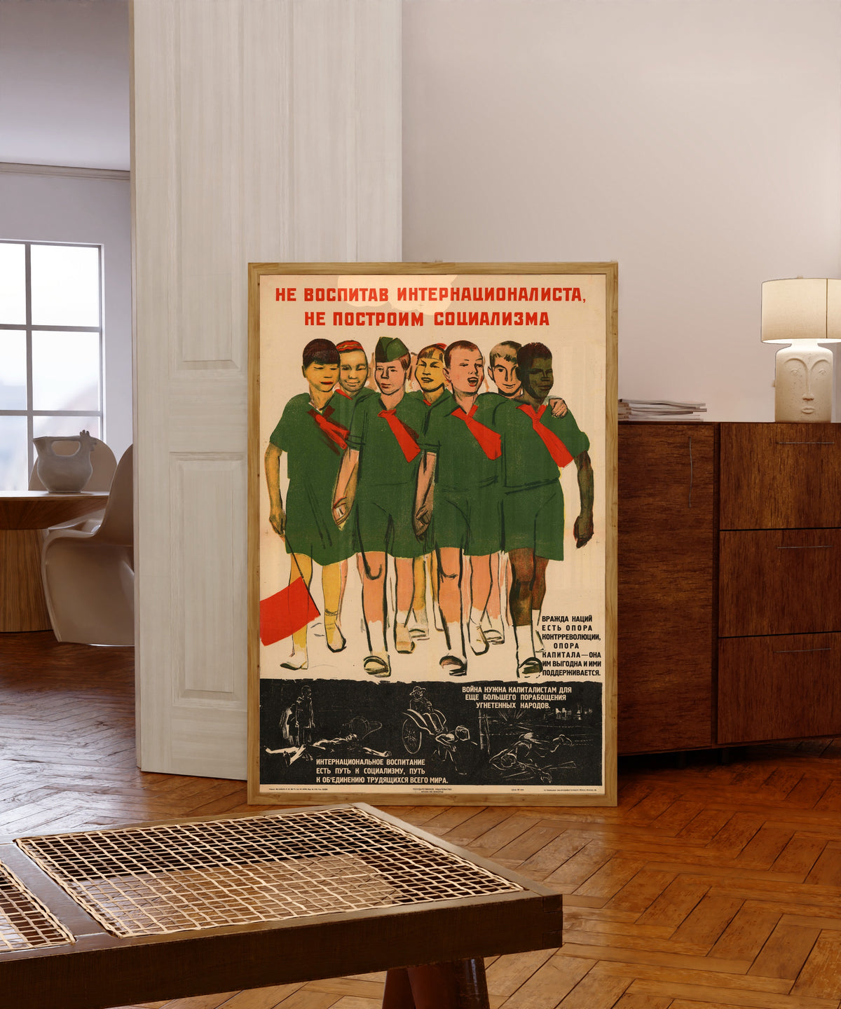 Framed art print of Without bringing up an internationalist, we will not build socialism, in a light wood frame leaning in a warm room with a parquet floor