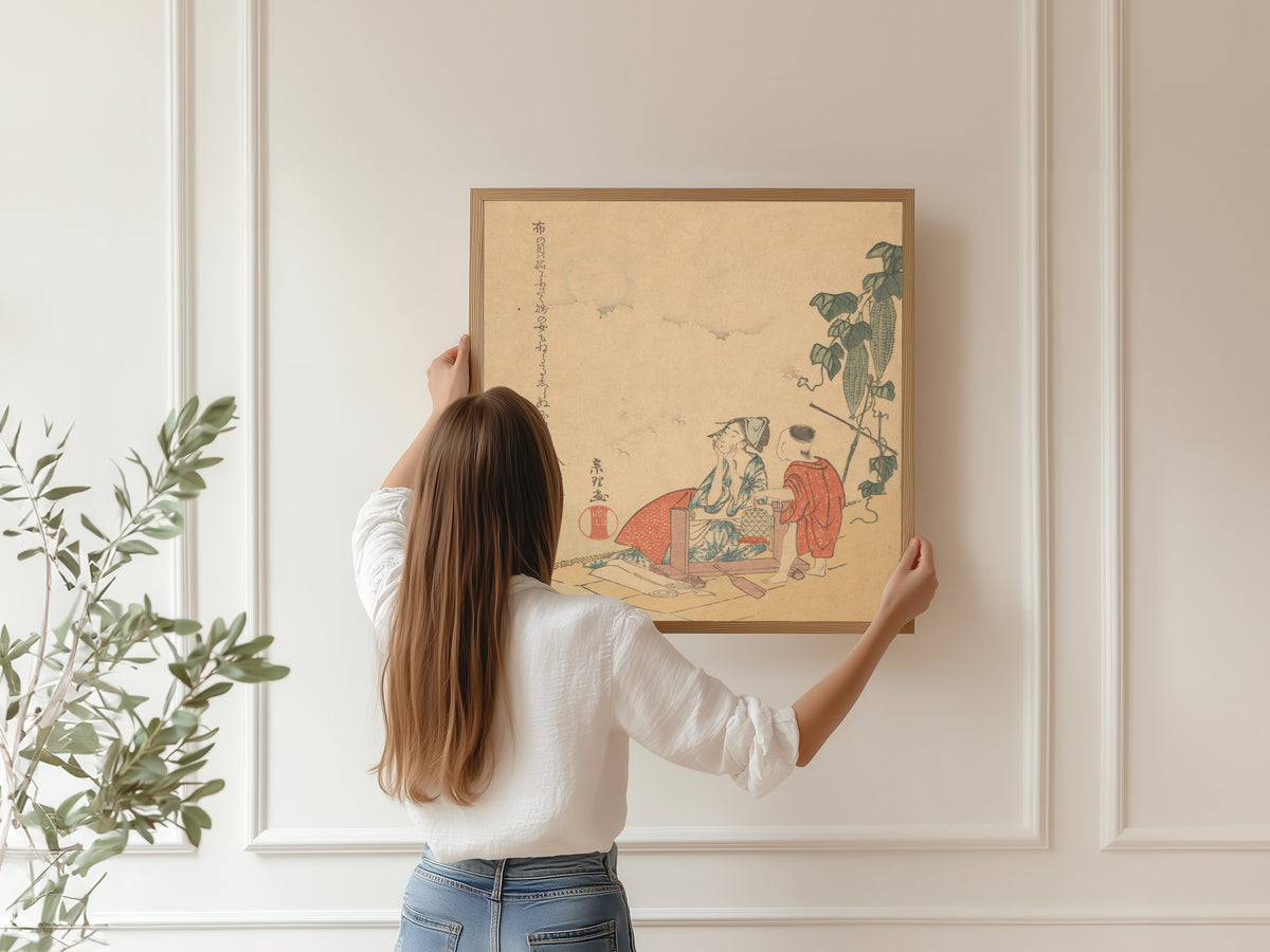 Framed art print of Woman and Boy with Melon Plant by Katsushika Hokusai, hung on a panelled wall