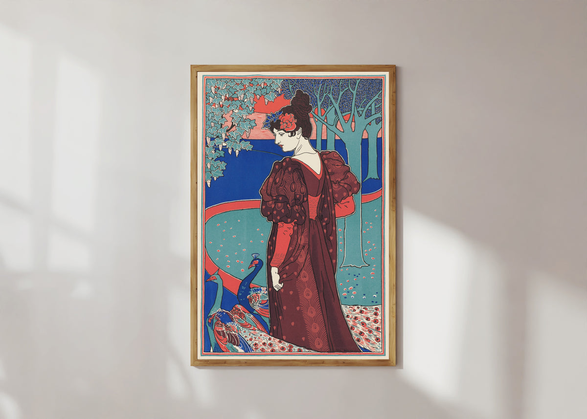 Framed art print of Woman with Peacocks (La Femme au Paon) by Louis Rhead, in a light wood frame on a sunlit white wall