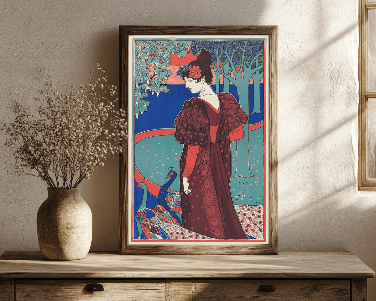 Framed art print of Woman with Peacocks (La Femme au Paon) by Louis Rhead, in a dark wood frame leaning on a rustic console beside dried flowers