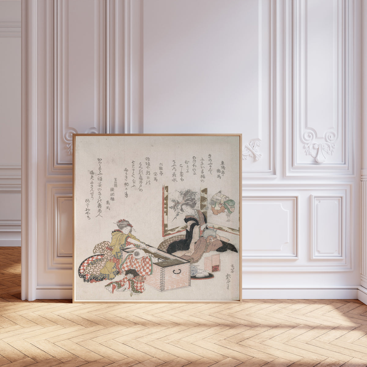 Framed art print of Women Preparing Tea Around the Fire-Holder by Katsushika Hokusai, leaning against pale pink panelling on a herringbone floor