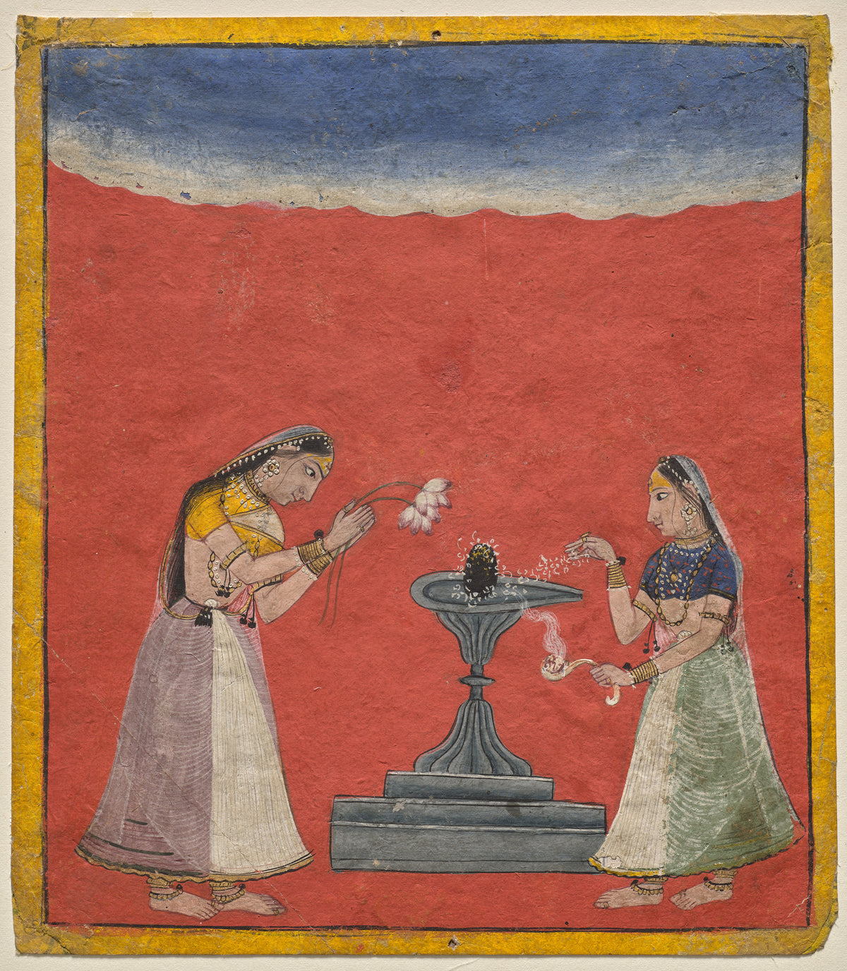 Women worshiping a Shiva linga: Devagandhari Ragini of Hindol Raga by Pahari school — Two women make offerings at a grey shrine against a red field