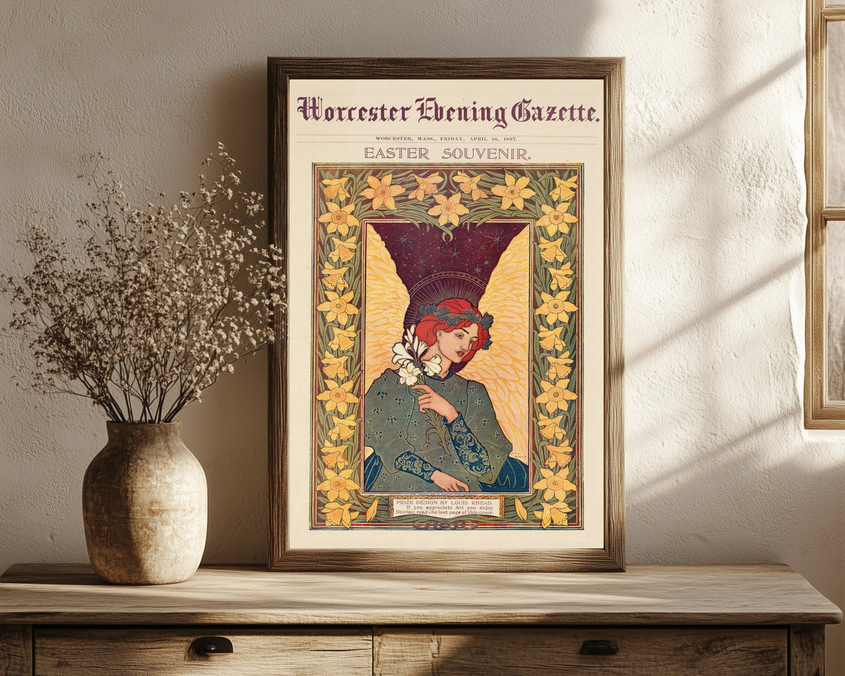 Framed art print of Worcester Evening Gazette, Easter Souvenir by Louis Rhead, in a dark wood frame leaning on a rustic console beside dried flowers