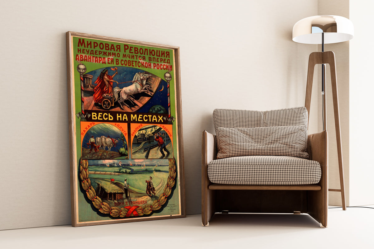 Framed art print of World Revolution Rushes Irresistibly Forward, leaning against a wall beside an armchair and a floor lamp