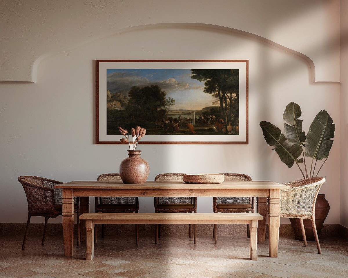 Framed art print of Worship of the Golden Calf by Claude Lorrain, above a wooden dining table