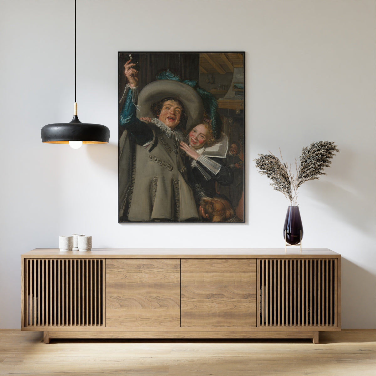 Framed art print of Young Man and Woman in an Inn by Frans Hals, above a slatted wood sideboard