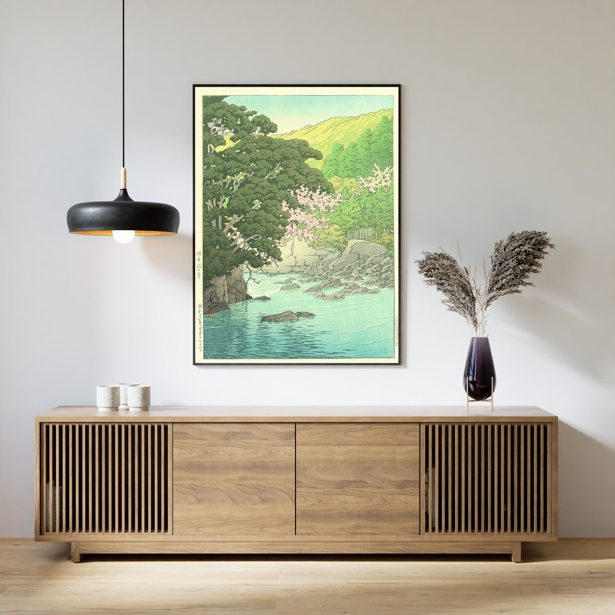 Framed art print of Yugashima, Izu by Kawase Hasui, above a slatted wood sideboard