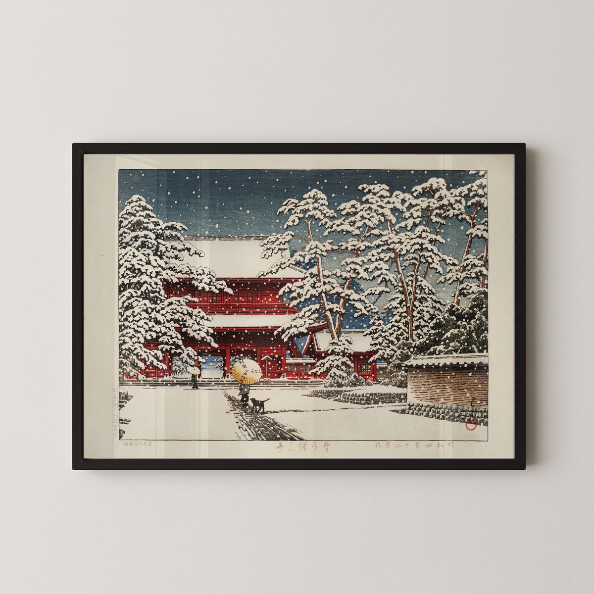 Framed art print of Zojoji Temple in Snow by Kawase Hasui, in a black frame on a pale wall