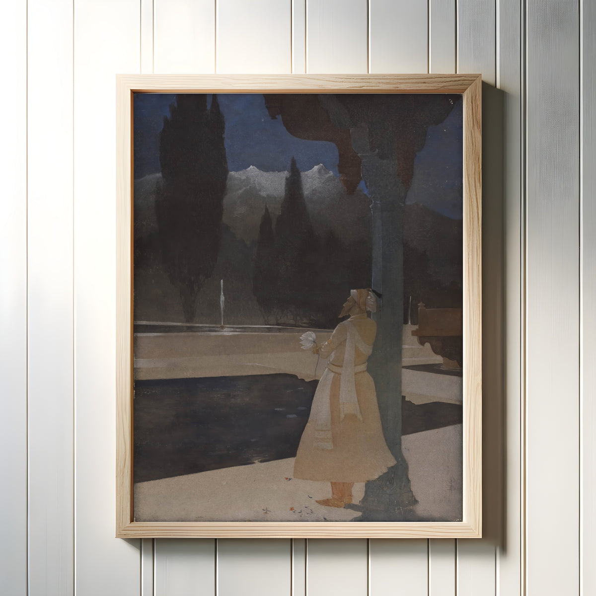 Framed art print of Night at the Shalimar by Abanindranath Tagore, in a light wood frame on a white panelled wall