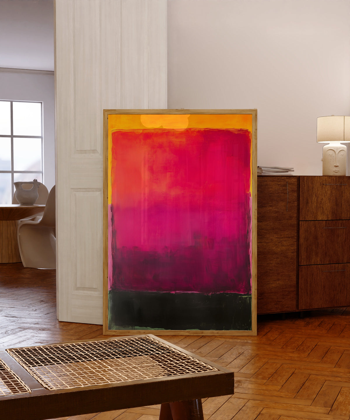 Framed art print of Black and Purple (Colour Field) by After Mark Rothko, in a light wood frame leaning in a warm room with a parquet floor