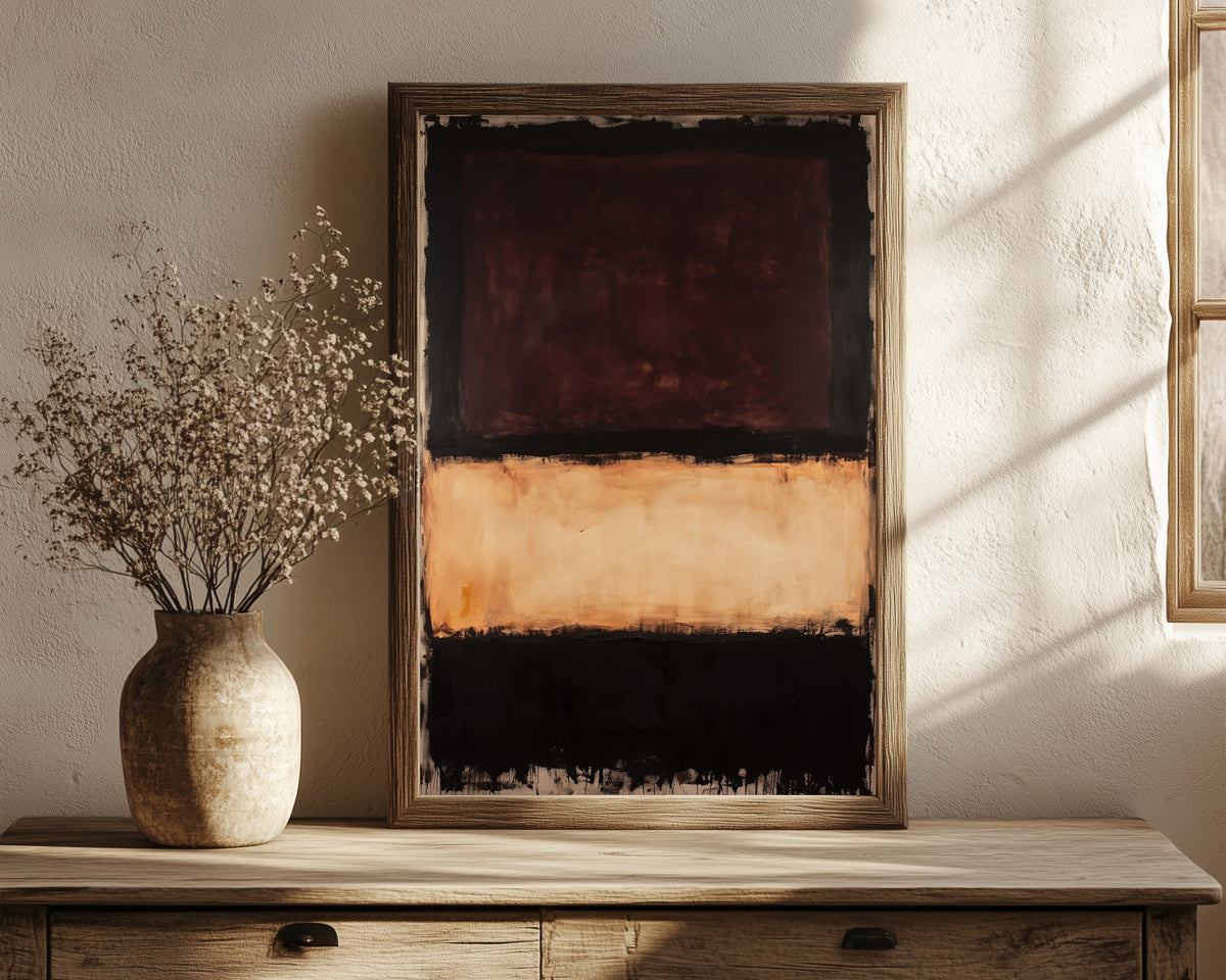 Framed art print of Colour Field: Beige, Brown, Black by After Mark Rothko, in a dark wood frame leaning on a rustic console beside dried flowers