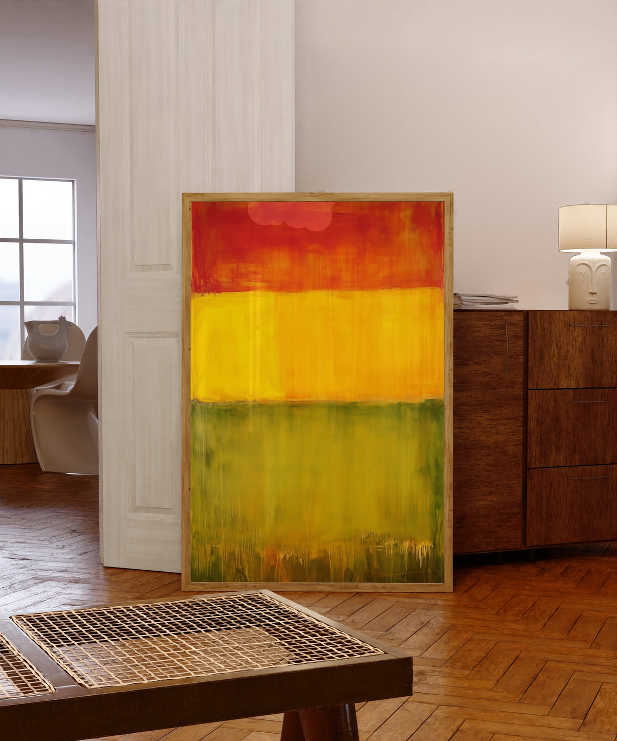 Framed art print of Green, Yellow and Red (Colour Field) by After Mark Rothko, in a light wood frame leaning in a warm room with a parquet floor