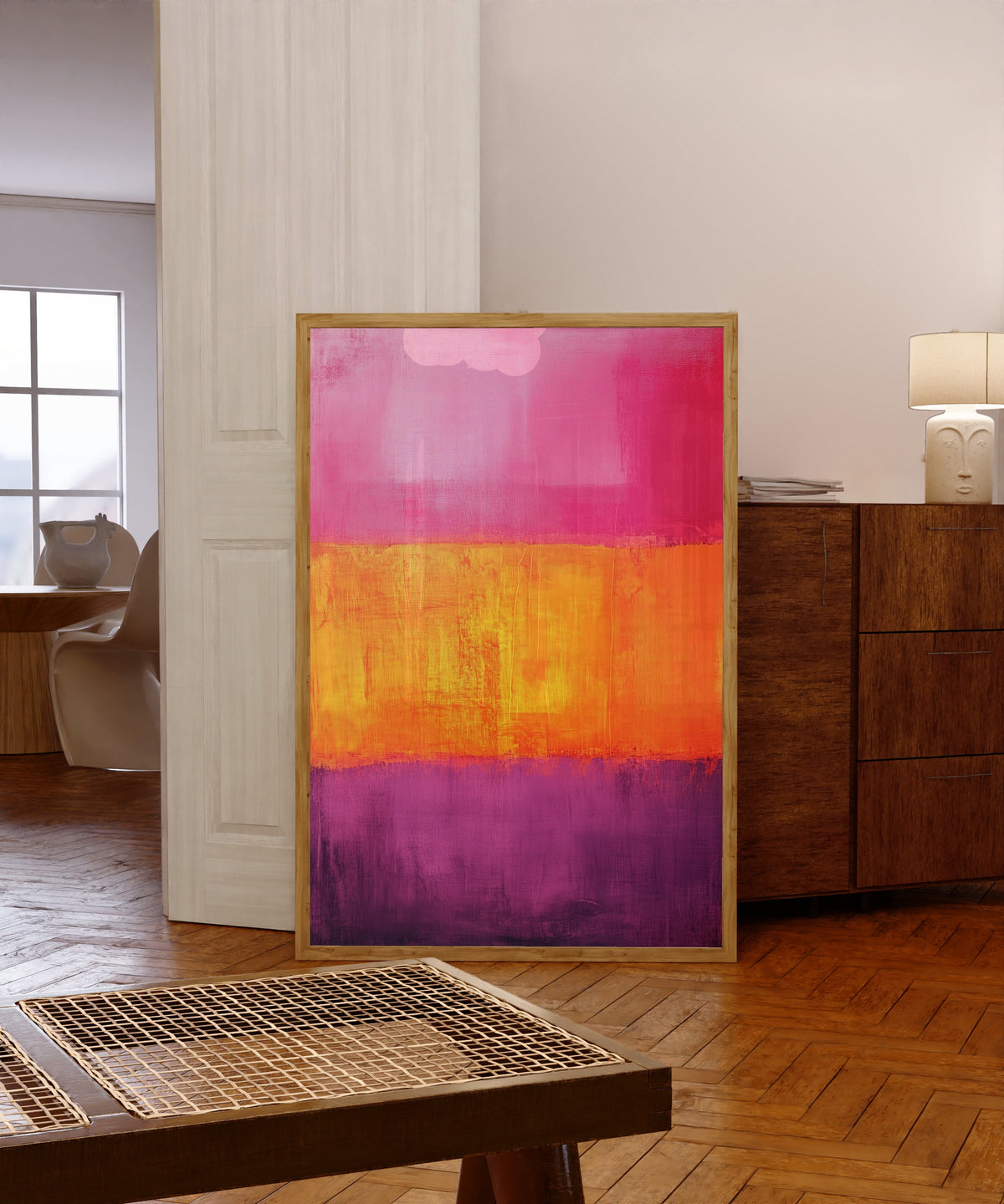 Framed art print of Orange and Purple II (Colour Field) by After Mark Rothko, in a light wood frame leaning in a warm room with a parquet floor