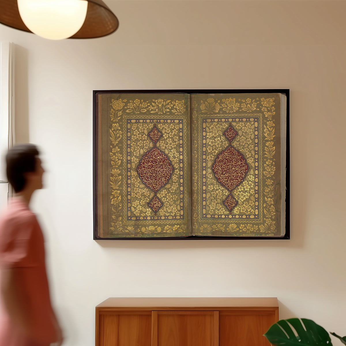 Framed art print of Book of Prayers: Illuminated Opening with Crimson Medallions by Ahmad Nairizi, in a slim black frame on a warm wall in a sunlit room
