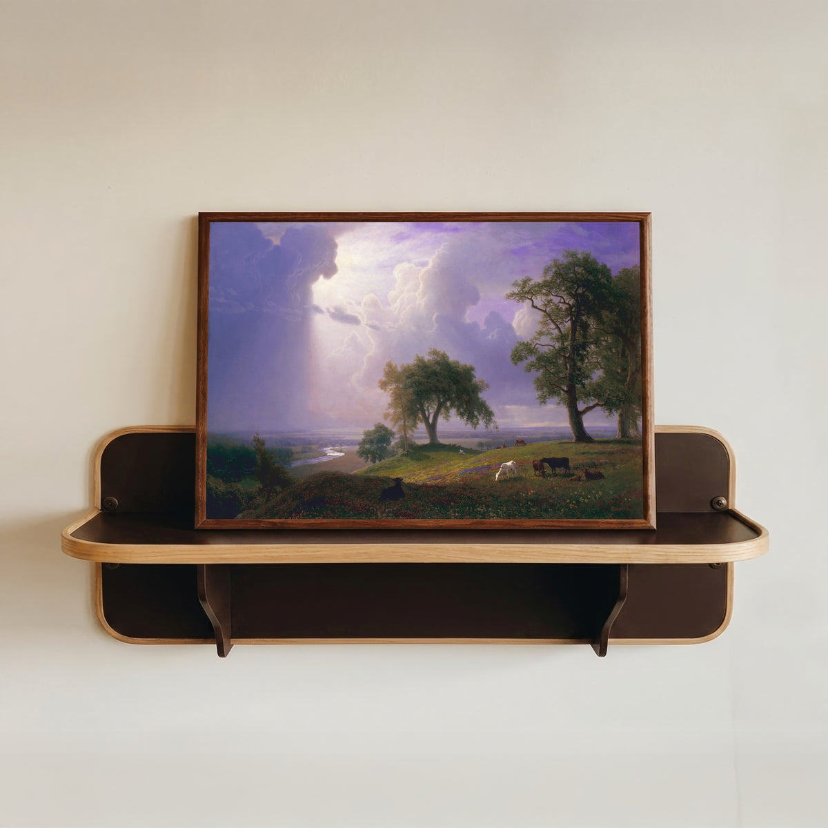 Framed art print of California Spring by Albert Bierstadt, in a dark wood frame resting on a wall shelf