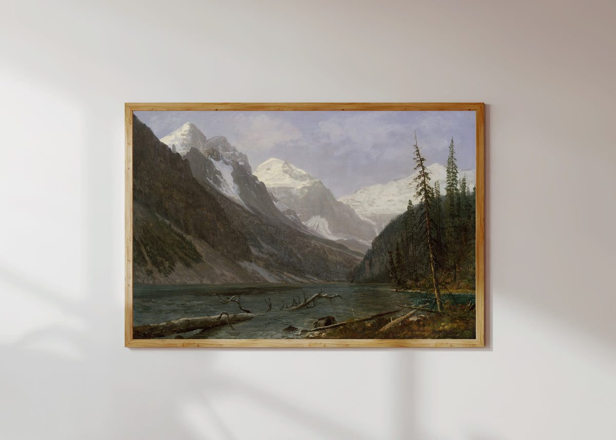 Framed art print of Canadian Rockies (Lake Louise) by Albert Bierstadt, in a light wood frame on a sunlit white wall