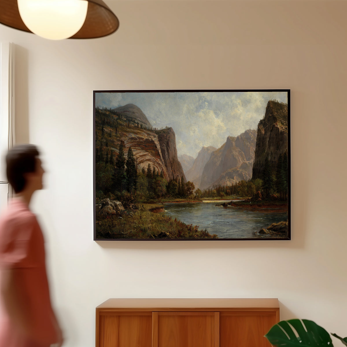 Framed art print of Gates of the Yosemite by Albert Bierstadt, in a slim black frame on a warm wall in a sunlit room