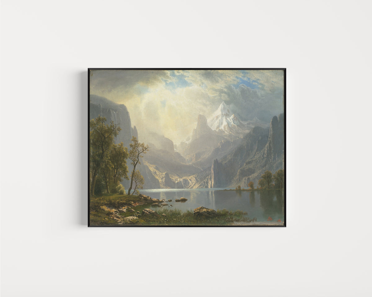 Framed art print of In the Sierras by Albert Bierstadt, in a slim black frame on a plain white wall