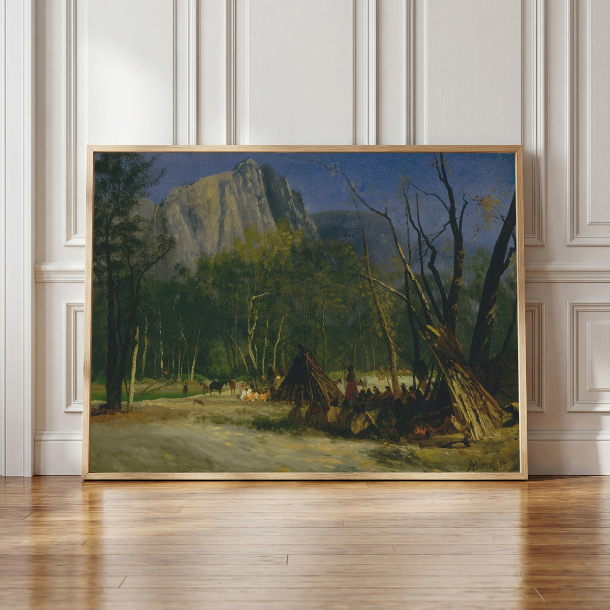 Framed art print of Indians in Council, California by Albert Bierstadt, in a light wood frame leaning against a panelled white wall