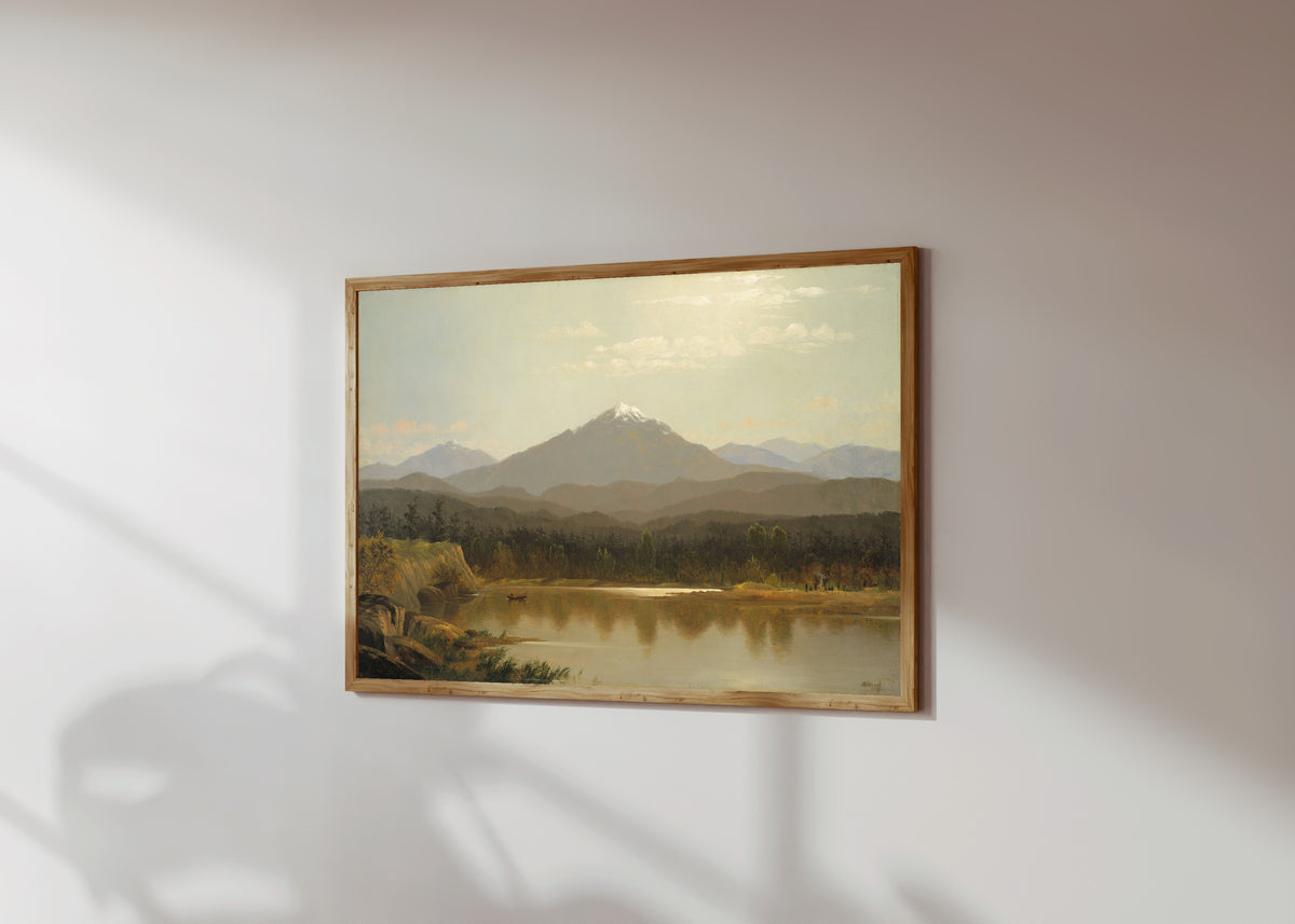 Framed art print of Laramie Peak by Albert Bierstadt, in a light wood frame on a sunlit white wall, seen at a slight angle