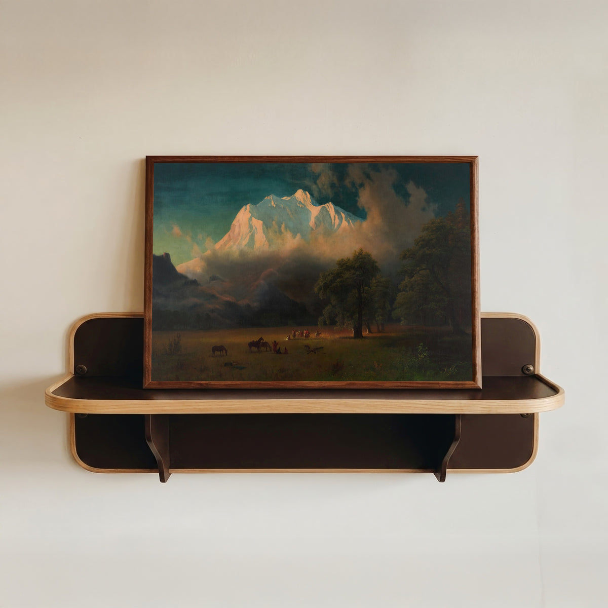 Framed art print of Mount Adams, Washington by Albert Bierstadt, in a dark wood frame resting on a wall shelf