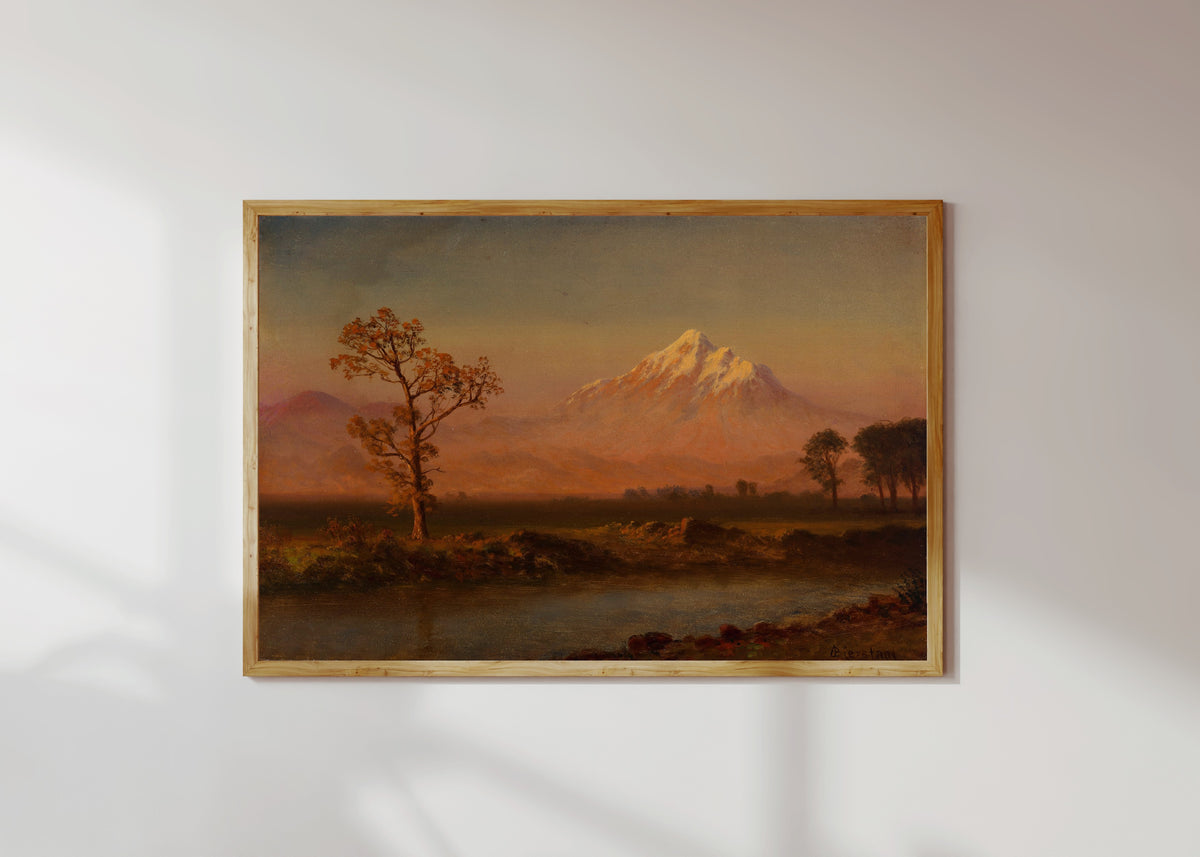 Framed art print of Mount Hood by Albert Bierstadt, in a light wood frame on a sunlit white wall